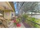 Covered patio with lake view, seating, and lush plants at 1375 Maseno Dr, Venice, FL 34292