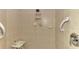 Walk-in shower with tiled walls and safety features at 1375 Maseno Dr, Venice, FL 34292