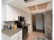 Kitchen featuring white cabinets, granite countertops, tile floors and stainless steel appliances at 14 Stone Mountain Blvd, Englewood, FL 34223