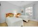 Guest bedroom with twin beds and an arched window at 1602 Gondola Park Dr # 1602, Venice, FL 34292