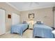 Guest bedroom with twin beds, light wood floors, and ample closet space at 1602 Gondola Park Dr # 1602, Venice, FL 34292