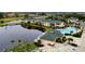 Aerial view of community with lake, pool, and multiple buildings at 1602 Gondola Park Dr # 1602, Venice, FL 34292