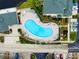 Aerial view of kidney-shaped community pool with surrounding lounge chairs at 1602 Gondola Park Dr # 1602, Venice, FL 34292