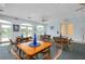 Bright community room with tables, chairs, and large windows at 1602 Gondola Park Dr # 1602, Venice, FL 34292