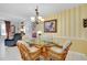 Bright dining area with glass table and wicker chairs, adjacent to kitchen at 1602 Gondola Park Dr # 1602, Venice, FL 34292