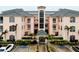 Three-story condo building with light peach walls and gray tile roofs at 1602 Gondola Park Dr # 1602, Venice, FL 34292