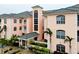 Tan colored building with a central entryway and palm trees at 1602 Gondola Park Dr # 1602, Venice, FL 34292