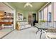 Bright lanai with tiled floor, seating area, and access to the outdoors at 1602 Gondola Park Dr # 1602, Venice, FL 34292