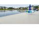 Waterfront patio with seating and umbrella, overlooking calm water at 1602 Gondola Park Dr # 1602, Venice, FL 34292
