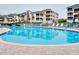 Inviting kidney-shaped pool with surrounding patio and lounge chairs at 1602 Gondola Park Dr # 1602, Venice, FL 34292