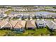 Bird's-eye view of a neighborhood with houses surrounding a pond at 17953 Grand Prosperity Dr, Venice, FL 34293