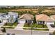 Three homes showcasing a community with similar architecture and landscaping at 17953 Grand Prosperity Dr, Venice, FL 34293