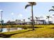 Cool baseball stadium surrounded by palm trees and a pond, creating a picturesque sports setting at 17953 Grand Prosperity Dr, Venice, FL 34293