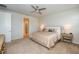Main bedroom with plush carpet, ceiling fan, and ensuite bath at 17953 Grand Prosperity Dr, Venice, FL 34293