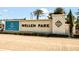 Welcome to Wellen Park, an attractive community marked by a beautifully designed sign and lush landscaping at 17953 Grand Prosperity Dr, Venice, FL 34293