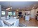 Open concept dining room with white table and chairs, adjacent to kitchen at 17953 Grand Prosperity Dr, Venice, FL 34293