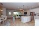 Open concept kitchen with white cabinets, island, and stainless steel appliances at 17953 Grand Prosperity Dr, Venice, FL 34293