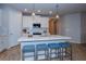 Kitchen island with white cabinets, quartz countertop and blue stools at 17953 Grand Prosperity Dr, Venice, FL 34293