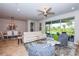 Open living area features white couch, tile floors, and view to backyard at 17953 Grand Prosperity Dr, Venice, FL 34293