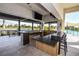 Outdoor kitchen with bar seating and pool views at 17953 Grand Prosperity Dr, Venice, FL 34293