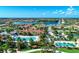 Gorgeous aerial view of a sprawling community with lakes, lush landscaping, and a resort-style pool at 18861 Bianchi St, Venice, FL 34293