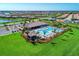 Aerial shot showcasing a community pool, clubhouse, and well-maintained green spaces in a waterfront neighborhood at 18861 Bianchi St, Venice, FL 34293