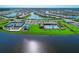 The aerial view shows a community with lakes, homes, walking paths, tennis courts, and a large community pool at 18861 Bianchi St, Venice, FL 34293