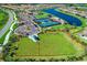 Aerial view of community amenities featuring a dog park, pool, clubhouse, pickleball courts and lakeside homes at 18861 Bianchi St, Venice, FL 34293