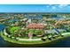 Picturesque aerial view of a community with lakes, landscaping, and amenities including a gazebo and sports courts at 18861 Bianchi St, Venice, FL 34293