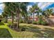 Well maintained backyard is beautifully landscaped with palm trees and shrubs at 18861 Bianchi St, Venice, FL 34293