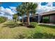 Lush backyard features covered lanai and palm trees at 18861 Bianchi St, Venice, FL 34293