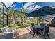 This covered lanai features an outdoor dining area with a view of the backyard at 18861 Bianchi St, Venice, FL 34293