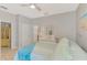 Comfortable bedroom with a ceiling fan, light gray walls, white closet doors and an ensuite bath at 18861 Bianchi St, Venice, FL 34293