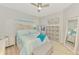 Comfortable bedroom with a ceiling fan, carpet flooring, closet, and beach themed decor at 18861 Bianchi St, Venice, FL 34293