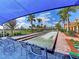 Bocce ball court with shading and chairs, manicured landscaping, and a view of the neighborhood at 18861 Bianchi St, Venice, FL 34293