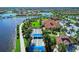 Aerial view of the bocce courts, community clubhouse, and lake, perfect for outdoor recreation and relaxation at 18861 Bianchi St, Venice, FL 34293