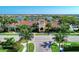 Beautiful clubhouse with lush landscaping, tile roof, and water view, perfect for community gatherings and events at 18861 Bianchi St, Venice, FL 34293