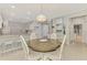 Dining room with a round table, white chairs, and an open concept at 18861 Bianchi St, Venice, FL 34293