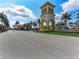 Grand entrance to the community featuring a decorative tower, landscaping, and a welcoming gatehouse at 18861 Bianchi St, Venice, FL 34293