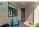 Cozy front porch area with seating, seahorse decoration, and view of the front door at 18861 Bianchi St, Venice, FL 34293