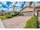 Charming single-story homes featuring two-car garages, well-manicured landscaping, and paver driveways at 18861 Bianchi St, Venice, FL 34293
