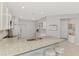 Bright kitchen with stainless steel appliances, white cabinets, and granite countertops at 18861 Bianchi St, Venice, FL 34293