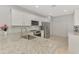 Modern kitchen with stainless steel appliances, white cabinetry, and granite countertops at 18861 Bianchi St, Venice, FL 34293