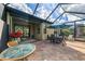 This covered lanai features an outdoor dining area and seating area at 18861 Bianchi St, Venice, FL 34293
