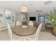 Open-concept living room with a round dining table and large windows at 18861 Bianchi St, Venice, FL 34293