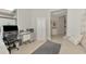 Functional home office setup with a desk, chair, storage, and a comfortable sofa at 18861 Bianchi St, Venice, FL 34293