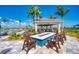 A common area featuring a fire pit surrounded by chairs and a covered area for parties at 18861 Bianchi St, Venice, FL 34293