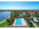 Community offers a large outdoor pool, lounge chairs, and well maintained landscaping, ideal for relaxing and swimming at 18861 Bianchi St, Venice, FL 34293