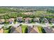 Wide aerial shot of the home in its neighborhood context, surrounded by green spaces and other residences at 20590 Granlago Dr, Venice, FL 34293