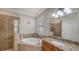Elegant bathroom featuring a soaking tub, granite countertops, and tiled shower at 20590 Granlago Dr, Venice, FL 34293